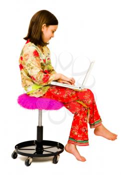 Royalty Free Photo of a Young Girl typing on a Laptop
