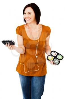 Royalty Free Photo of a Woman Smiling and Holding her Media Player and a Case of Cd's