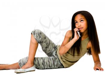 Royalty Free Photo of a Young Girl on the Floor Talking on her Mobile Phone