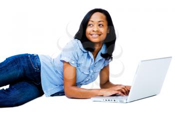 Royalty Free Photo of a Teenage Girl Lying on the Floor Using her Laptop