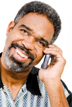 Royalty Free Photo of a Man Smiling and Talking on a Mobile Phone