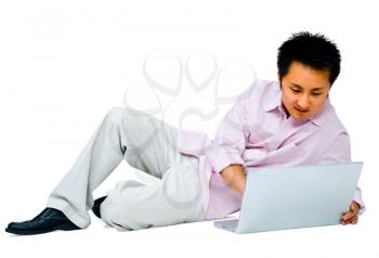 Happy young man using a laptop isolated over white