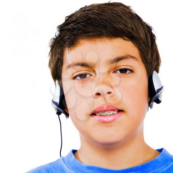 Boy listening to headphones isolated over white