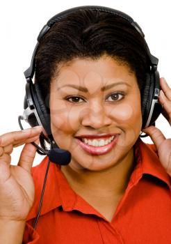 Businesswoman using a headset and smiling isolated over white