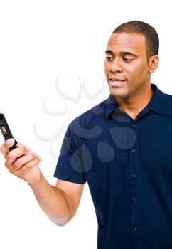 Mid adult man text messaging on a mobile phone isolated over white