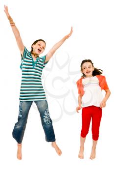 Excited girls jumping and smiling isolated over white