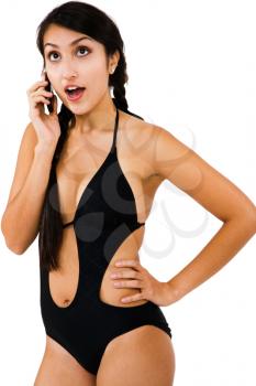 Middle Eastern woman talking on a mobile phone isolated over white
