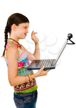 Girl using a laptop and smiling isolated over white