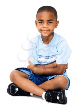 Sitting boy posing and smiling isolated over white