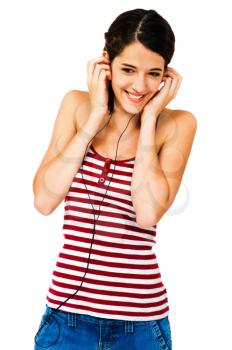 Young woman listening to music on earbud isolated over white