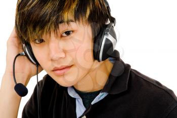 Portrait of a teenage boy wearing headphones and listening to music isolated over white