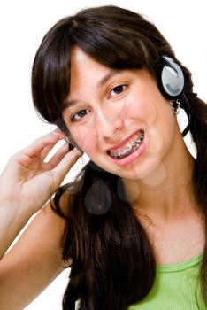 Latin American teenager wearing headphones and listening to music isolated over white