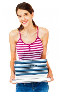 Smiling woman holding a stack of laptops isolated over white