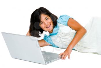 Asian girl using a laptop and smiling isolated over white