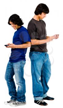 Young men text messaging on mobile phones isolated over white