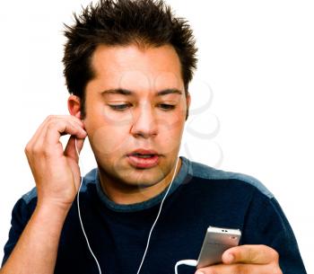 Close-up of a man listening to music on a MP3 player isolated over white
