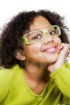 Girl wearing eyeglasses with hand on chin isolated over white
