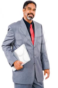 Mature businessman holding a laptop and smirking isolated over white