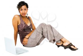 Portrait of a young woman using a laptop isolated over white