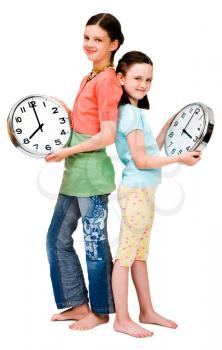 Cute girls holding clocks isolated over white