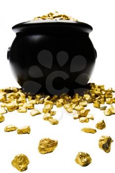 Gold nuggets spilling out from a pot isolated over white