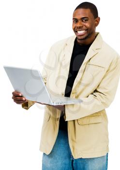 Happy man using a laptop and posing isolated over white