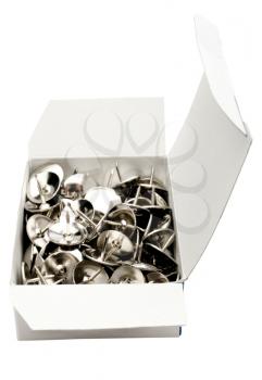 Thumbtacks in box isolated over white