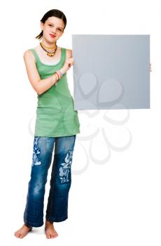 Happy girl showing a placard isolated over white
