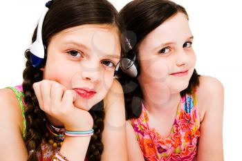 Portrait of girls listening to music on headphones isolated over white