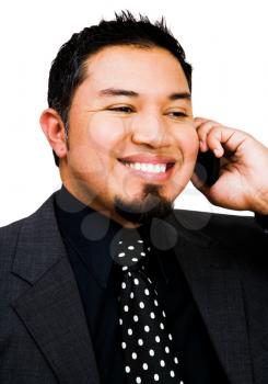 Young businessman talking on a mobile phone isolated over white