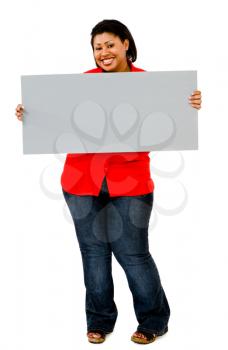 Woman showing an empty placard and smiling isolated over white