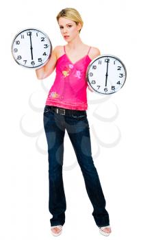 Caucasian woman holding clocks and posing isolated over white