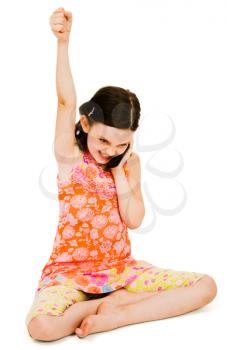 Excited girl talking on a mobile phone isolated over white