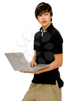 Teenager using a laptop and posing isolated over white