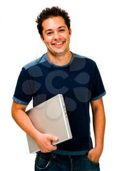 Close-up of a young man holding a laptop and smiling isolated over white