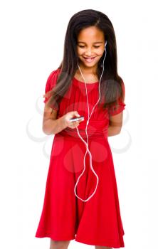 Happy girl listening to music on a MP3 player isolated over white