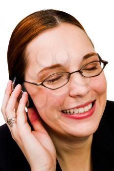 Businesswoman listening to music on a headphones and smiling isolated over white