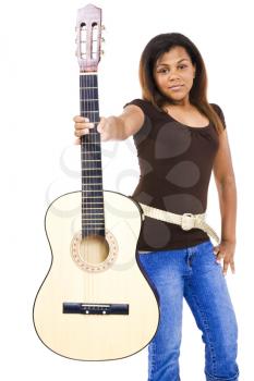 Girl showing a guitar and posing isolated over white