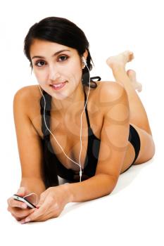 Beautiful woman listening to music on MP3 player isolated over white