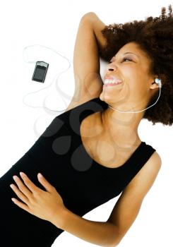 Beautiful woman listening to music on a MP3 player isolated over white