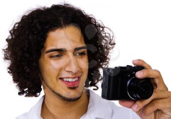 Man photographing with a camera and smiling isolated over white