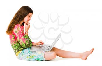 Girl thinking and working on a laptop isolated over white
