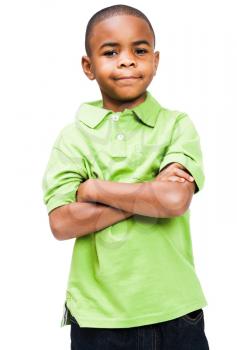 Smiling boy standing with his arms crossed isolated over white