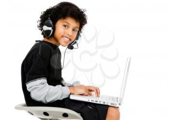 Happy boy using a laptop isolated over white