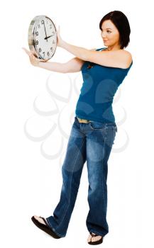 Young woman holding a clock isolated over white