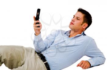 Man text messaging on a mobile phone isolated over white