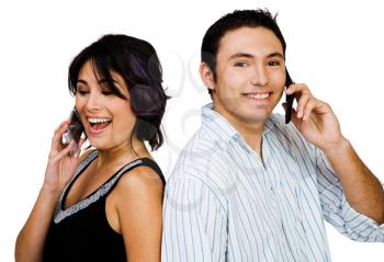 Close-up of a couple talking on mobile phones isolated over white