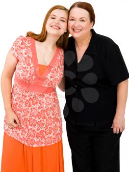 Mature woman and her daughter smiling together isolated over white