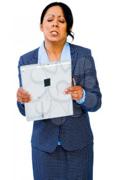 Angry businesswoman holding a laptop and posing isolated over white
