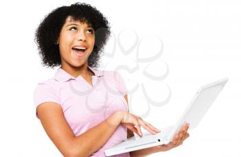 Fashion model using a laptop and smiling isolated over white
